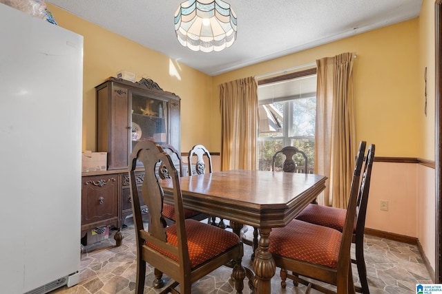 dining room with a textured ceiling