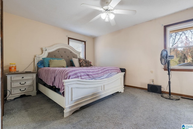 carpeted bedroom with multiple windows and ceiling fan