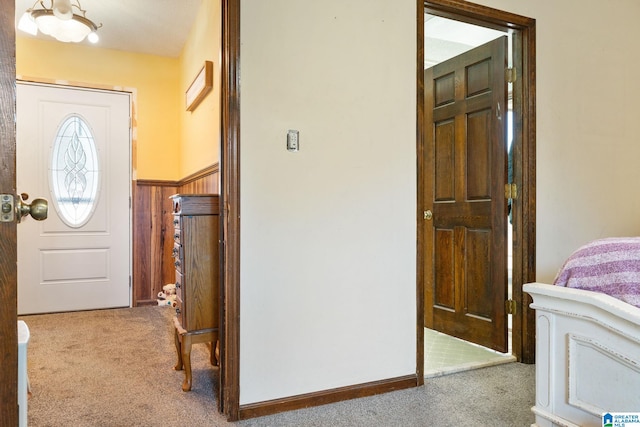 foyer featuring light colored carpet