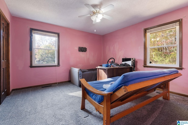 bedroom featuring carpet flooring, a textured ceiling, and ceiling fan