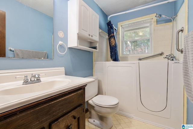 full bathroom with shower / bath combo with shower curtain, vanity, a textured ceiling, and toilet