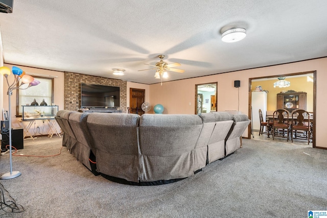 living room with a textured ceiling, carpet floors, and ceiling fan