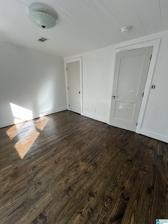 empty room featuring dark wood-type flooring