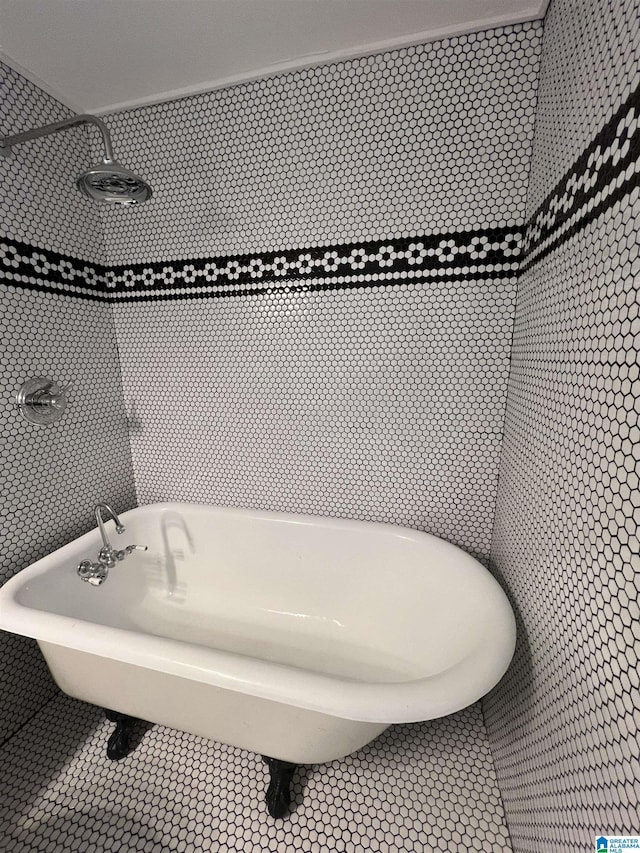 bathroom with tile patterned floors and a tub