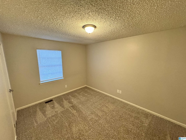 carpeted spare room with a textured ceiling