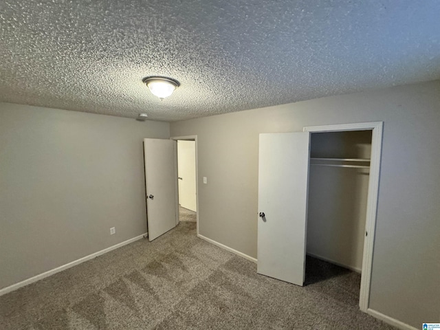 unfurnished bedroom with a closet, carpet floors, and a textured ceiling