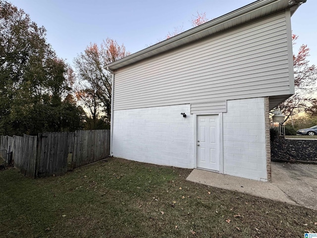 outdoor structure at dusk featuring a yard