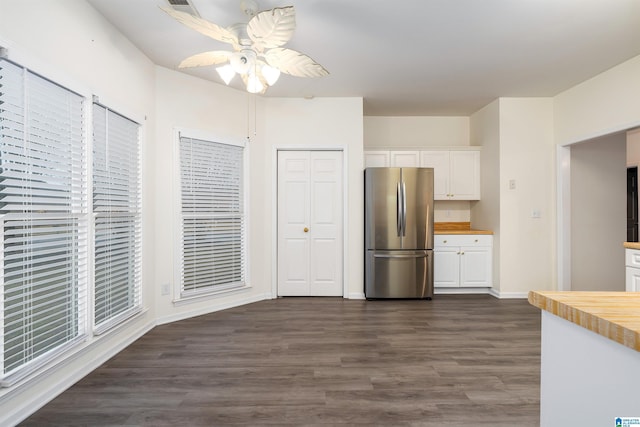 kitchen featuring white cabinets, dark hardwood / wood-style flooring, stainless steel refrigerator, and ceiling fan