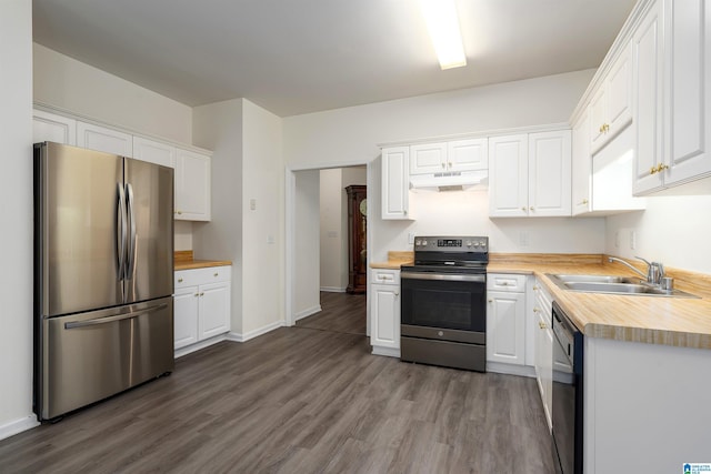 kitchen with butcher block counters, white cabinetry, hardwood / wood-style floors, and stainless steel appliances