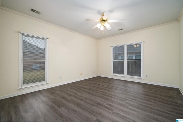 empty room with ceiling fan, crown molding, and dark wood-type flooring