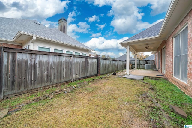 view of yard featuring a patio, ceiling fan, and central air condition unit