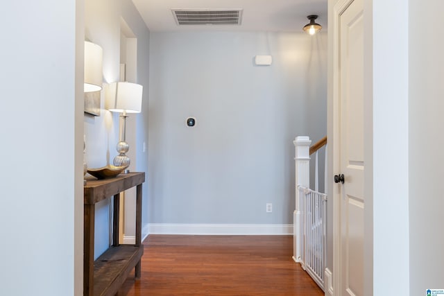 hallway with dark hardwood / wood-style flooring