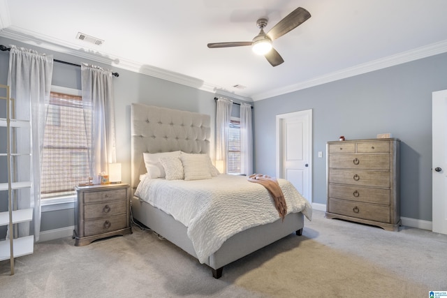 bedroom with ceiling fan, crown molding, and light carpet