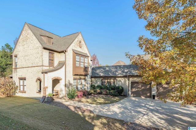 view of front of property featuring a garage and a front lawn