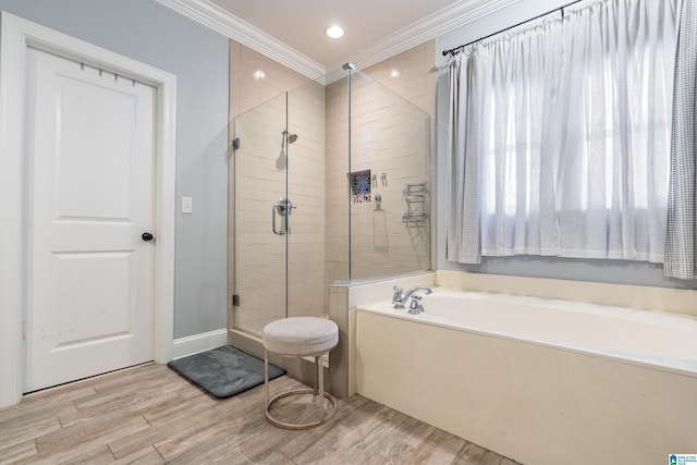 bathroom featuring hardwood / wood-style flooring, crown molding, and shower with separate bathtub