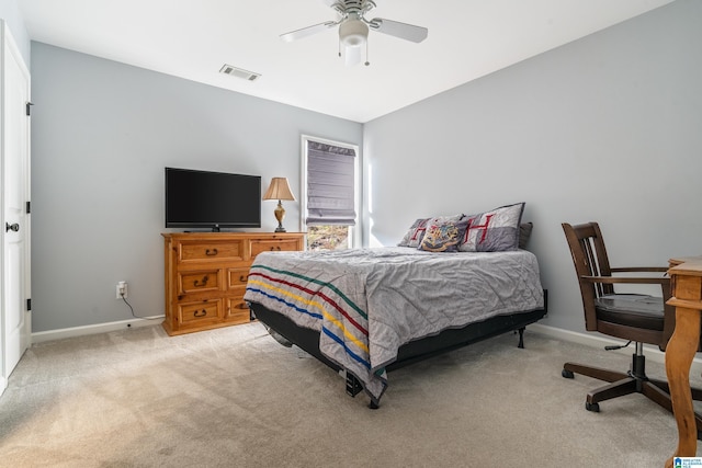 bedroom with ceiling fan and light colored carpet