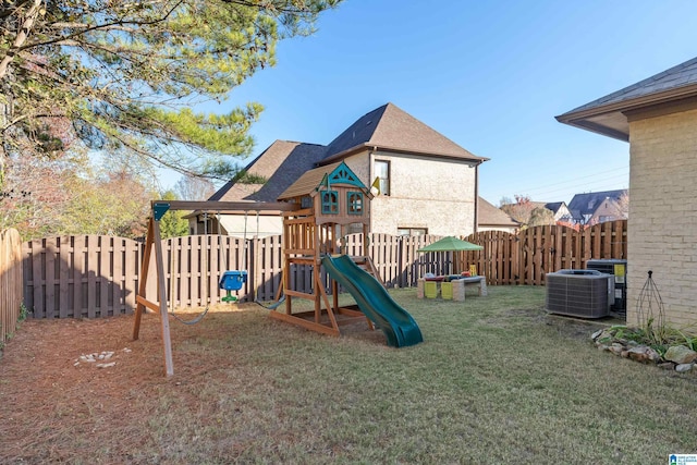 view of jungle gym with central AC and a lawn