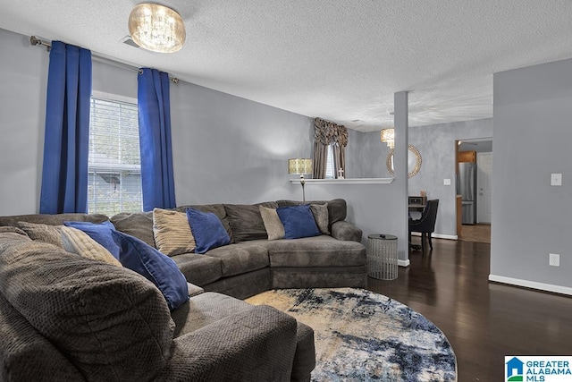 living room with a textured ceiling and dark wood-type flooring