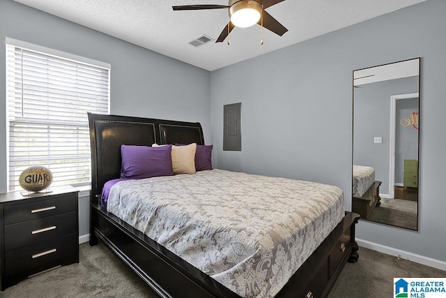 carpeted bedroom featuring a textured ceiling, electric panel, and ceiling fan