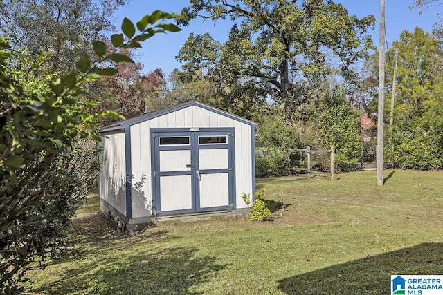 view of outdoor structure featuring a lawn