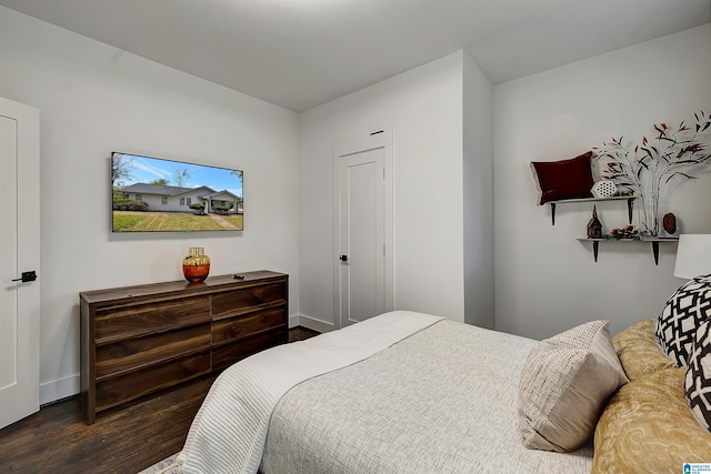 bedroom with dark hardwood / wood-style flooring