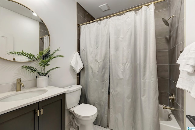 full bathroom with vanity, shower / bath combination with curtain, and toilet