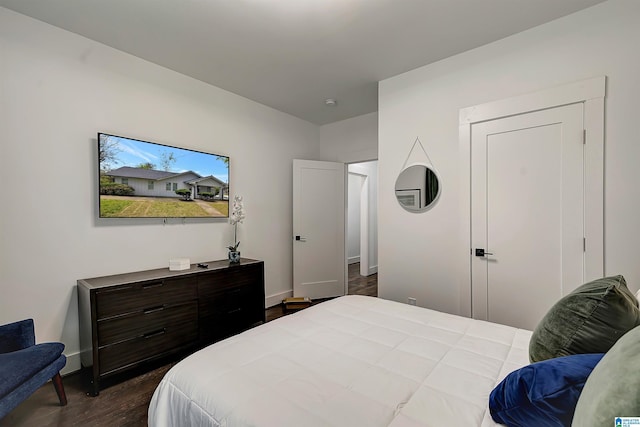 bedroom with dark hardwood / wood-style flooring