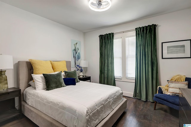 bedroom with dark hardwood / wood-style floors