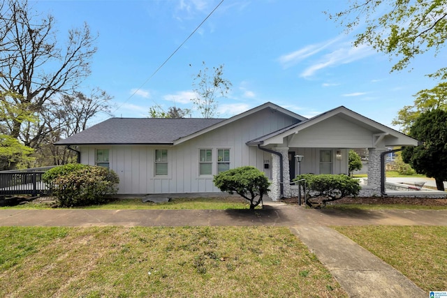 single story home with a front lawn and a wooden deck