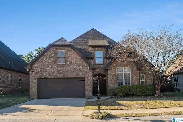 view of front of property featuring a garage and a front lawn