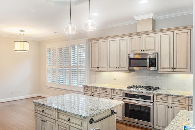 kitchen featuring decorative light fixtures, light stone counters, and stainless steel appliances