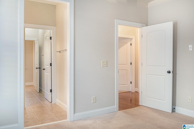 unfurnished bedroom with light colored carpet