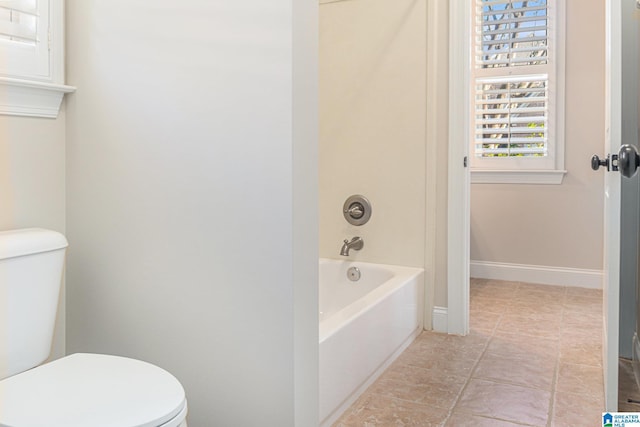 bathroom featuring shower / bath combination and toilet