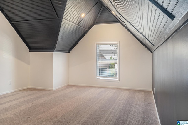 bonus room featuring carpet flooring and vaulted ceiling