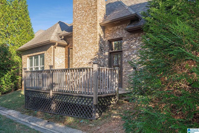 view of property exterior featuring a wooden deck