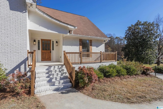 view of exterior entry with covered porch