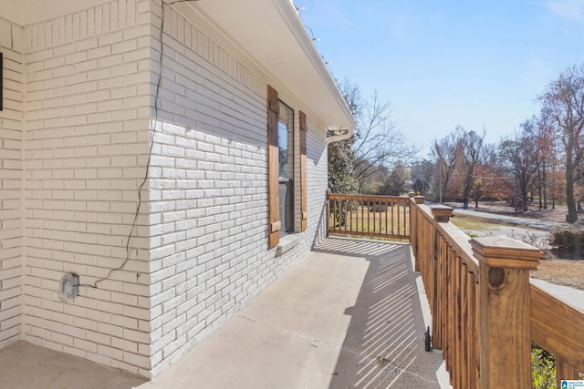 view of side of home featuring a wooden deck