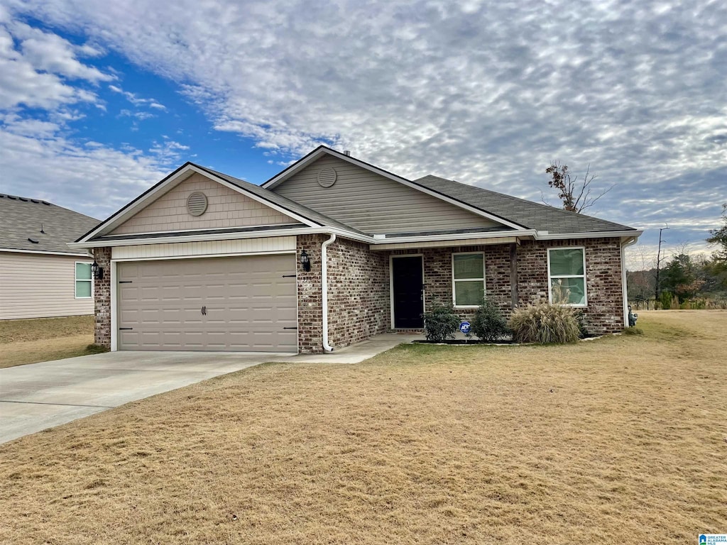 view of front of home featuring a garage and a front lawn