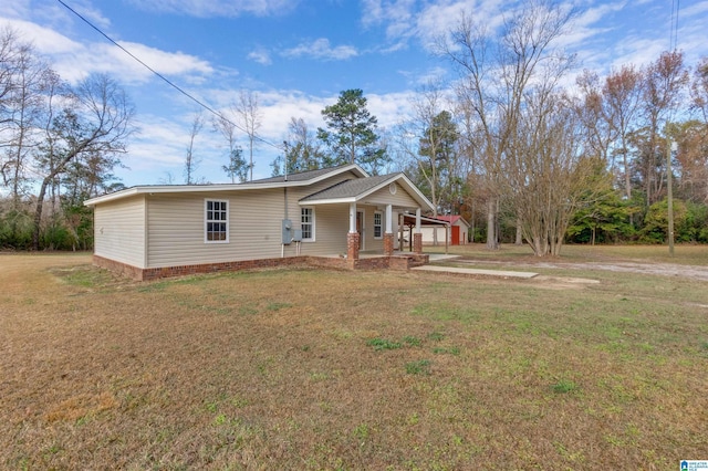 view of front of property with covered porch and a front yard