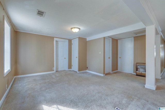 carpeted spare room featuring crown molding