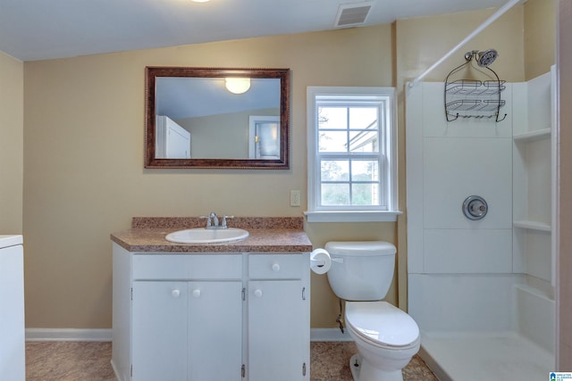 bathroom featuring tile patterned floors, vanity, vaulted ceiling, and toilet