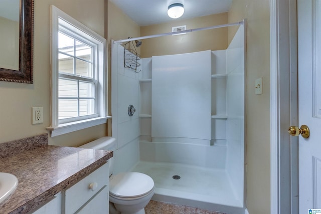 bathroom with toilet, walk in shower, and a wealth of natural light