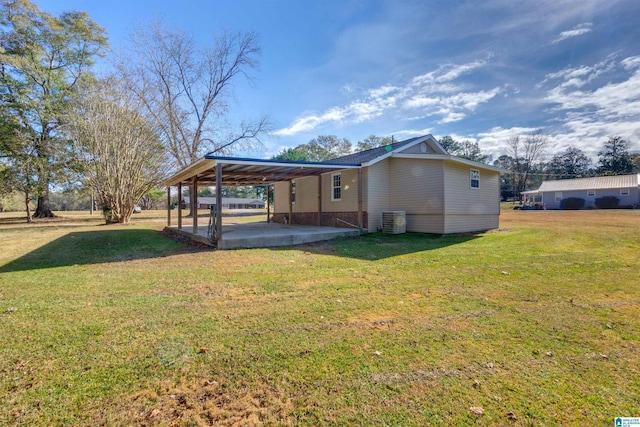 exterior space featuring cooling unit, a patio area, and a lawn