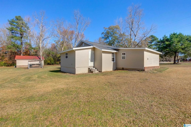 rear view of property featuring a yard