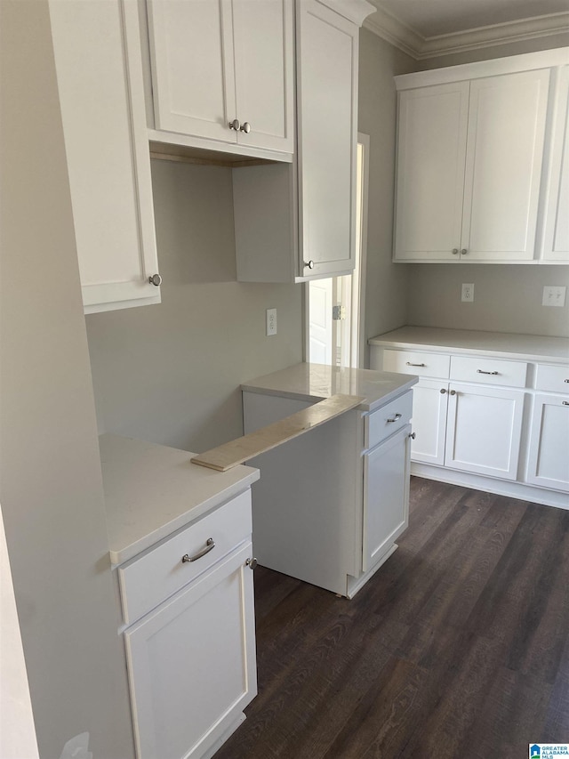 kitchen featuring white cabinetry, crown molding, and dark wood-type flooring