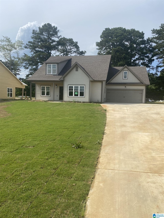 view of front of home with a garage and a front lawn