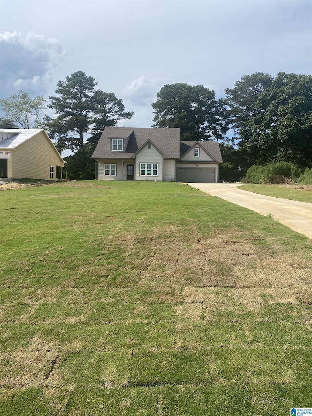 view of front of property featuring a garage and a front lawn