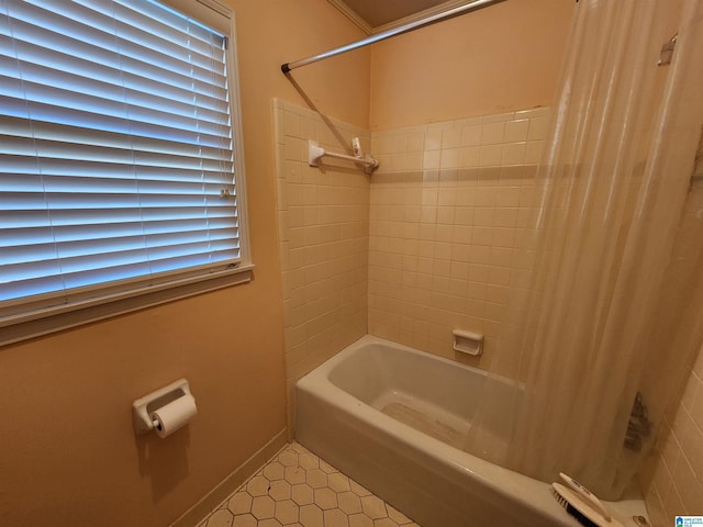 bathroom with tile patterned flooring and shower / bath combination with curtain