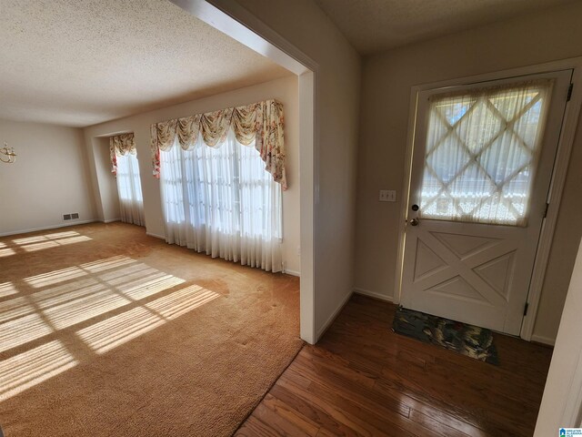 foyer with hardwood / wood-style floors and a textured ceiling