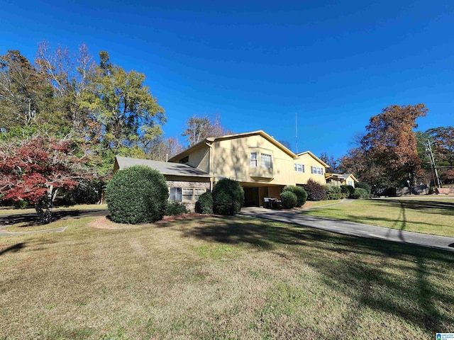 view of property exterior with a lawn